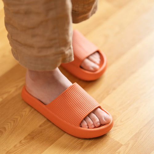 a person wearing orange slippers